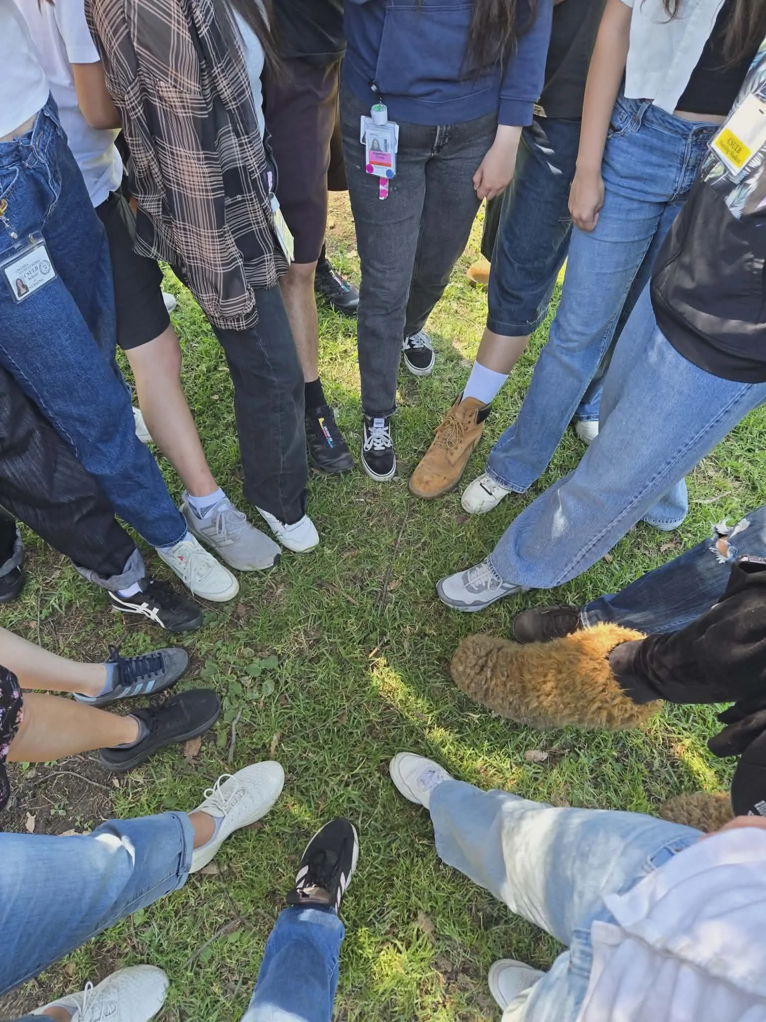 Community members standing together in a circle outdoors